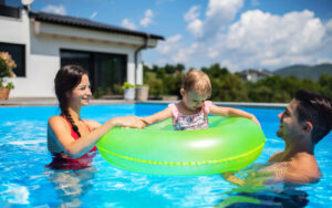 family in backyard pool